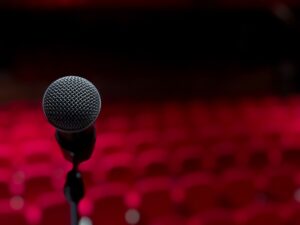 Microphone in a theater of empty red seats
