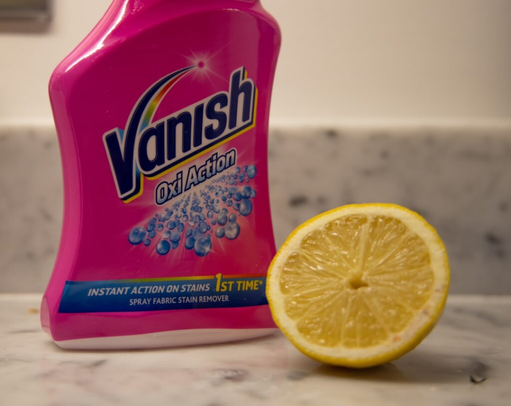 Chemical and natural cleaner, side by side on marble kitchen counter.